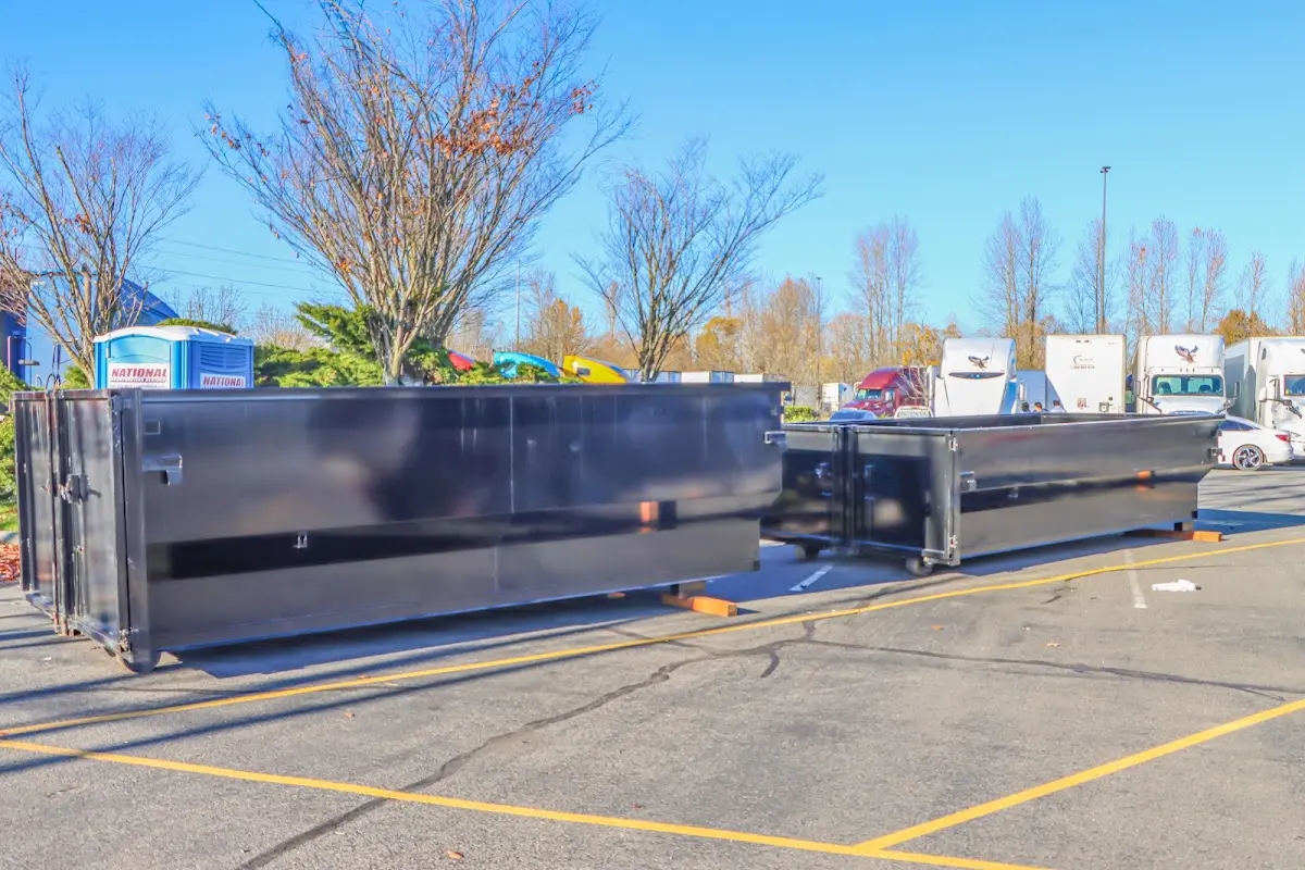 Professional dumpster rental service with roll-off container on residential driveway in Leland